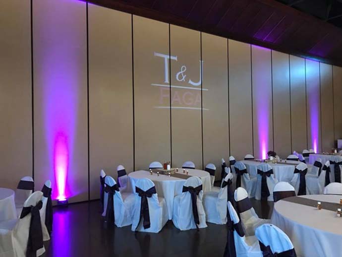 uplights shown on wall at wedding reception